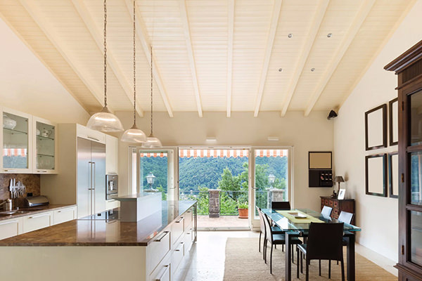 Open-plan kitchen and dining room under a white insulated ceiling
